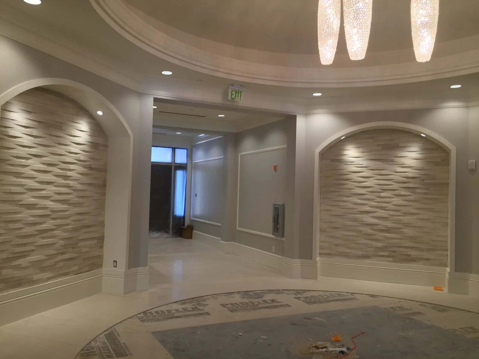 Custom dimensional stone accent walls and marble floor installation by Dynasty Tile in Southwest Florida